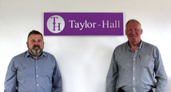 Richard Taylor and Mark Hall, friendly, financial advisors stand in their office